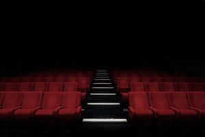 Dark movie theater with glowing screen