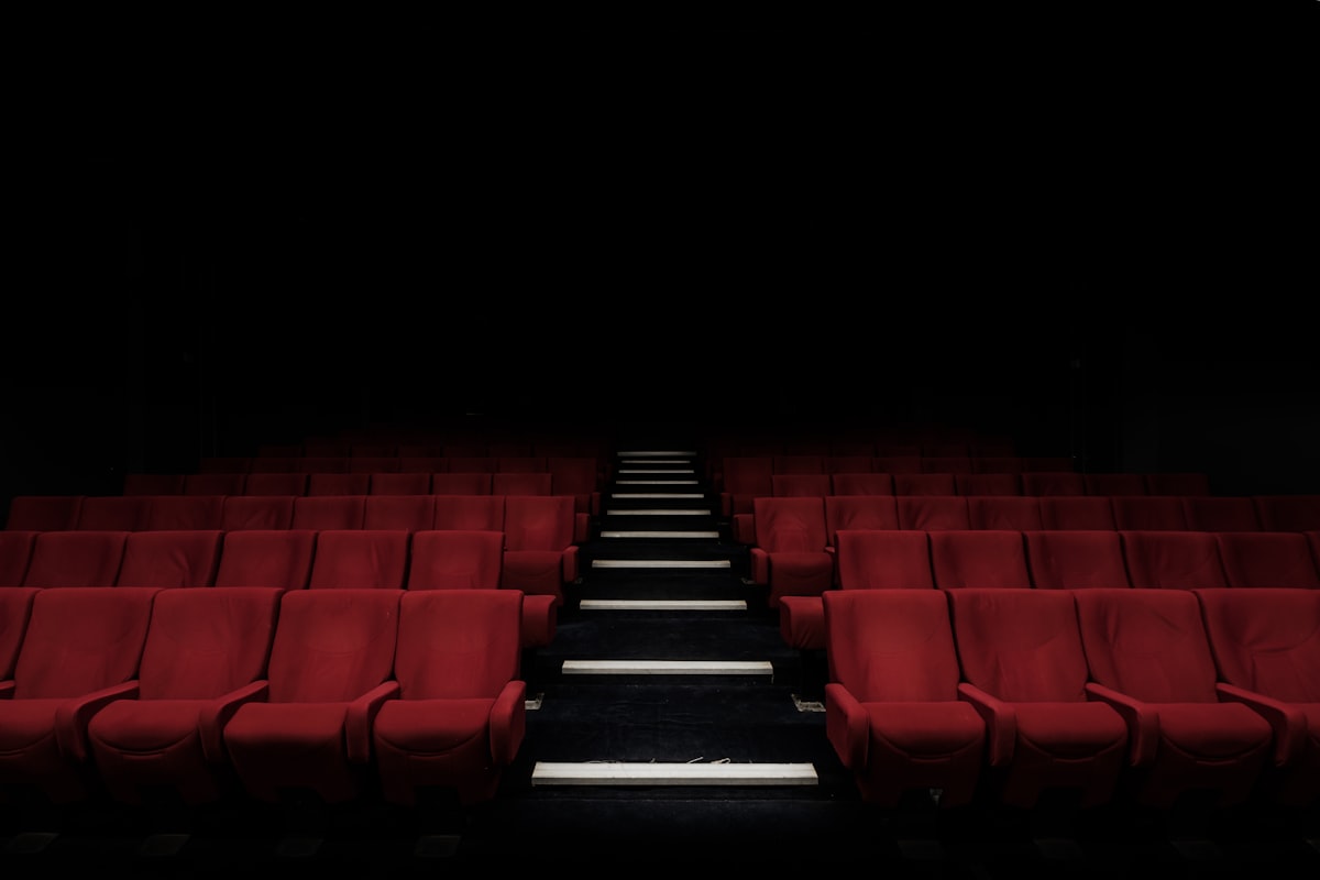Dark movie theater with glowing screen