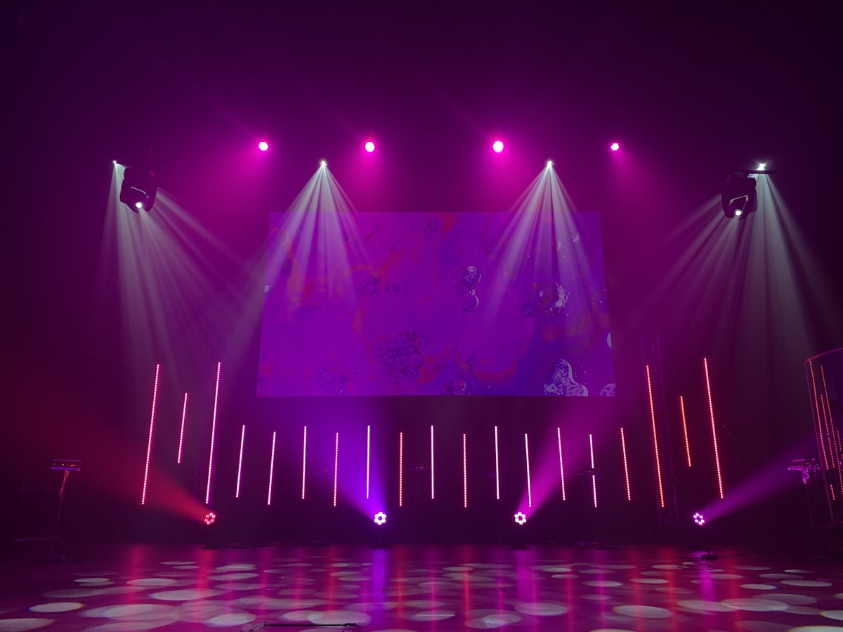 J-Pop idol concert stage with dramatic lighting representing the Love Live franchise