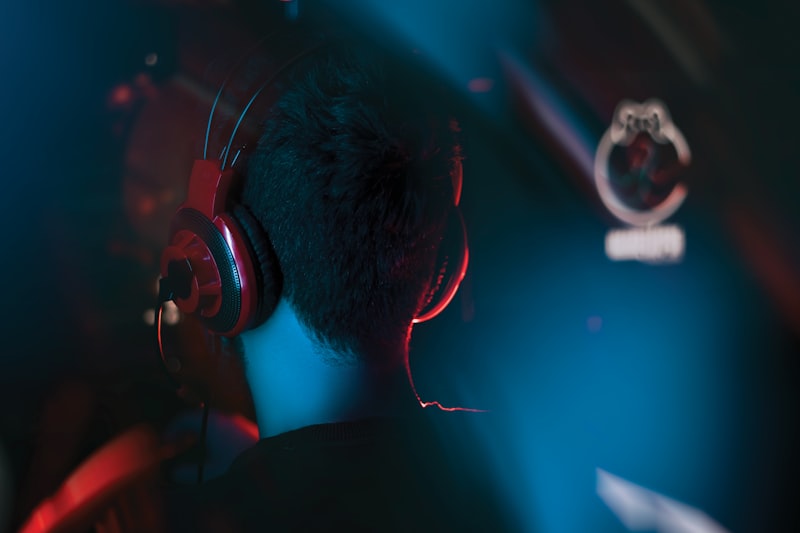 Person wearing headphones listening to anime music on a streaming platform