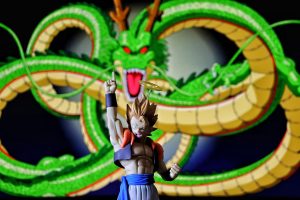 Dragon Ball gogeta action figure with Shenron dragon behind it
